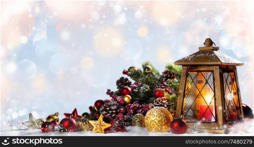Burning candles , lantern and christmas decoration on glowing bokeh background. Lantern and christmas decoration