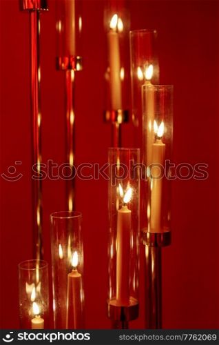 burning candles on a dark night in a wooden lantern as a decoration for a holiday