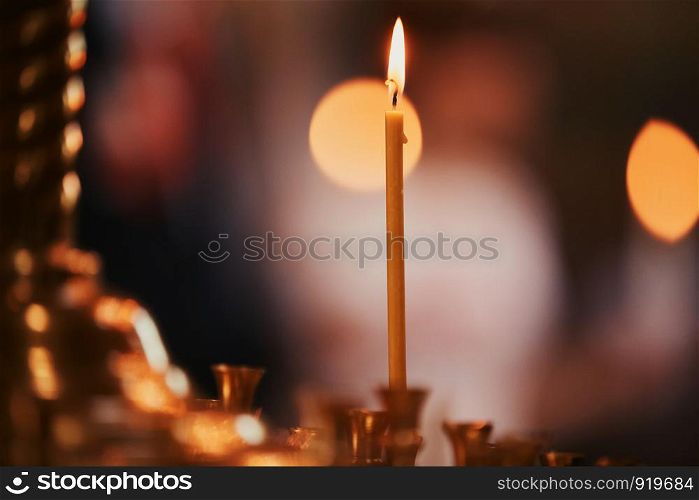 Burning candles oncandlestick against dark background at home. Vintage style. Calm romantic atmosphere. candles in the interior. Burning candles on bronze candlestick against dark background at home.candles in the interior. Vintage style. Calm romantic atmosphere. Horizontal image for design.