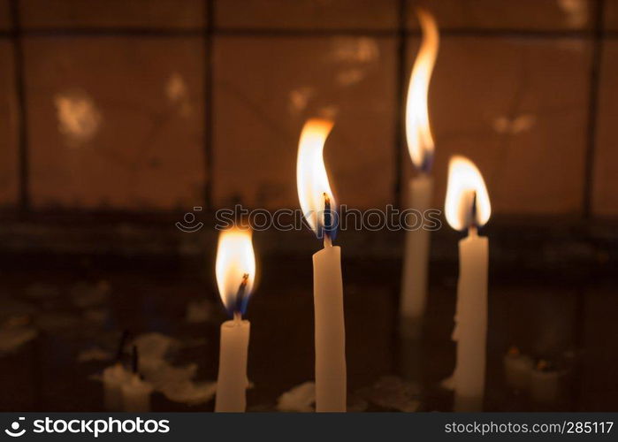 Burning candles with candle light in the dark