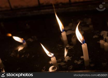 Burning candles with candle light in the dark