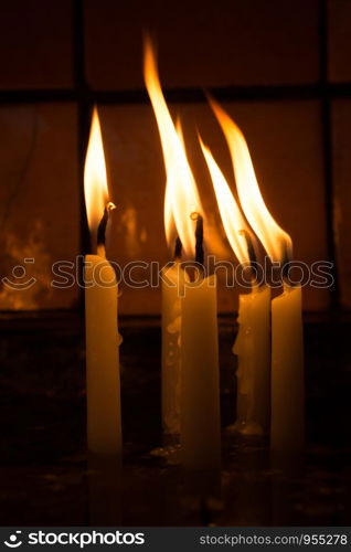 Burning candles with candle light in the dark