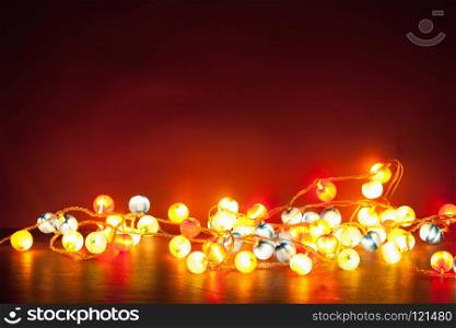 burning christmas lights decoration over red background