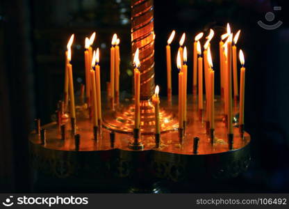 burning church candles. burning church candles on candlesticks in church