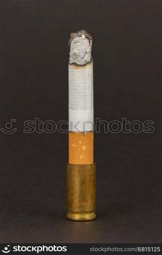 Burning cigarette in an old tin ashtray, isolated