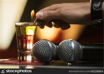 burning drink shot. Closeup photo in a bar where barmen burning drink shot