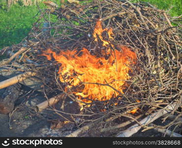 Burning fire. Bonfire in a meadow amidst the grass