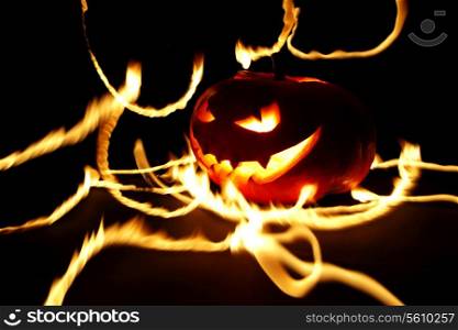 Burning halloween pumpkin on black background