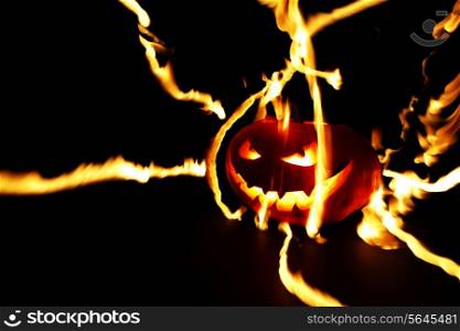 Burning halloween pumpkin on black background