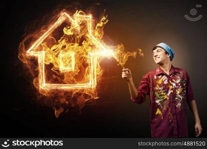 Burning house sign. Painter draw glowing light house symbol on dark background