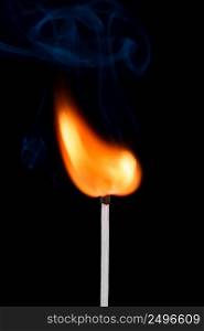 Burning match stick with fire and smoke isolated on black background