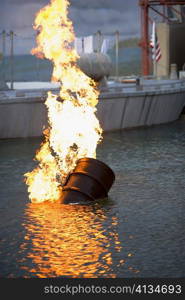 Burning oil drum in water
