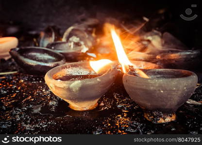 Burning oil lamps at temple. Traditional offering in buddhist and hindu temple