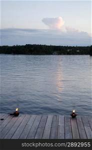 Burning oil lamps on a pier, Lake of the Woods, Ontario, Canada