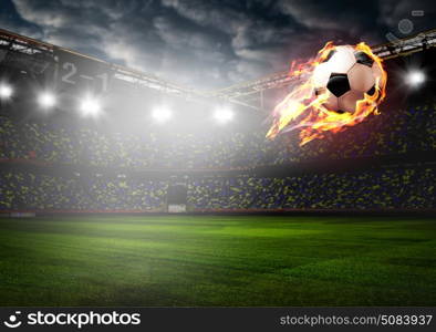 Burning soccer ball on stadium. Soccer or football ball on fire at stadium