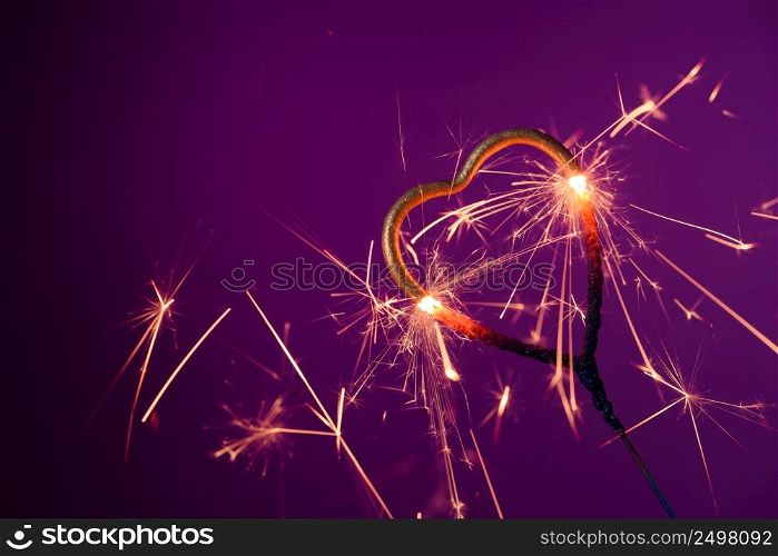 Burning sparkler heart shaped. Love wedding valentines day party bengal fire.