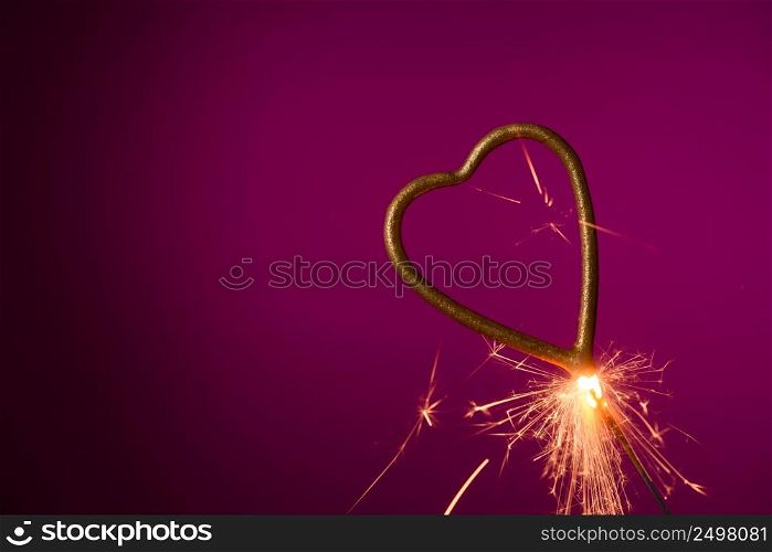 Burning sparkler in shape of heart