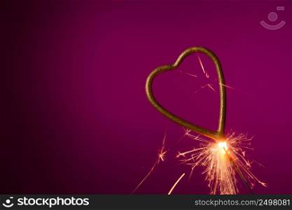 Burning sparkler in shape of heart