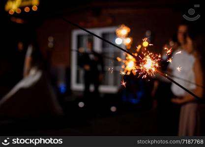 Burning sparkler on dark background.space for text. happy new year and merry christmas concept. happy holidays. selective focus.. Burning sparkler on dark background.space for text. happy new year and merry christmas concept. happy holidays. selective focus