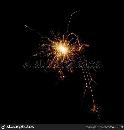 Burning sparkler star isolated on black. Spark design element.