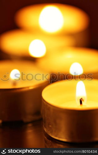 Burning warm candles close-up on a table