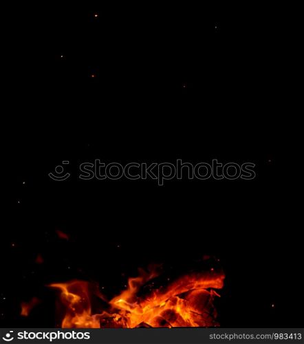 burning wooden logs and large orange flame, close up