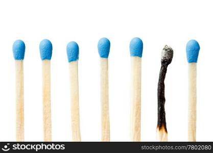 burnt match and a whole blue matches isolated on a white background