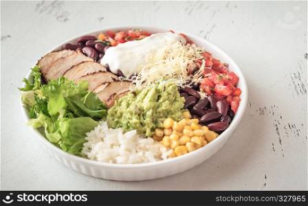 Burrito bowl with chicken, salsa, corn, rice, kidney beans and guacamole