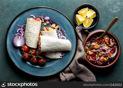 Burritos wraps with chicken meat and vegetables, traditional Mexican cuisine, fastfood