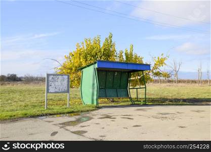Bus stop in the village. The stopper next to the tree. Bus stop in the village. The stopper next to the tree.