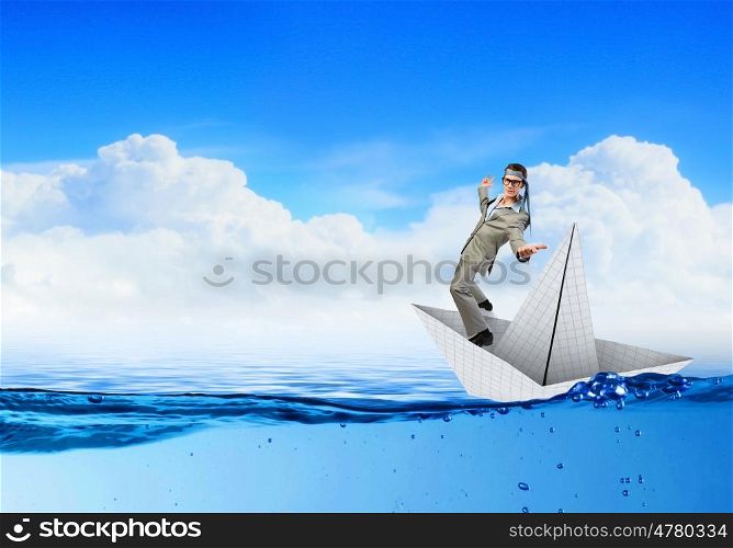 Businesman on paper boat. Businessman escapes from the crisis on paper boat
