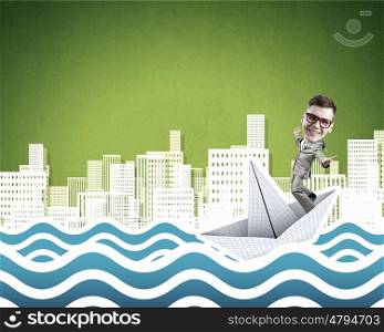 Businesman on paper boat. Businessman escapes from the crisis on paper boat