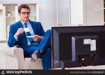 Businesman watching tv in office