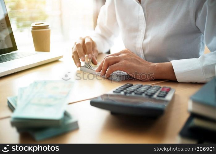business accountant counting on banknote in office