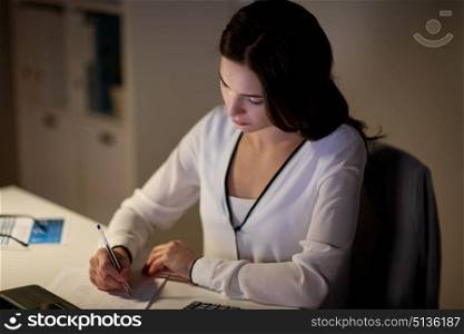 business, accounting, overwork, deadline and people concept - woman with tax form and calculator working at night office. woman with calculator and papers at night office. woman with calculator and papers at night office