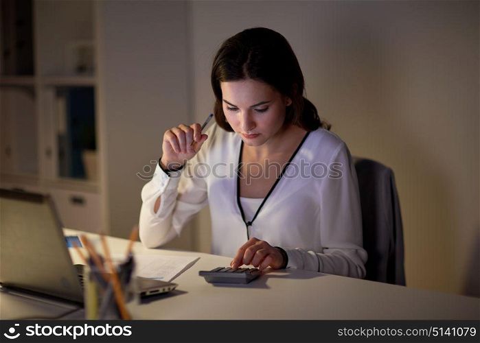 business, accounting, overwork, deadline and people concept - woman with tax form and calculator working at night office. woman with calculator and papers at night office