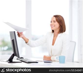 business adn education concept - smiling businesswoman giving papers in office