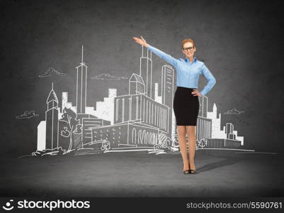 business, advertising and office concept - smiling businesswoman in eyeglasses pointing her hand