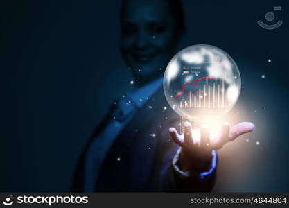 Business ambitions. Close up of businesswoman holding bubble with graphs in hand