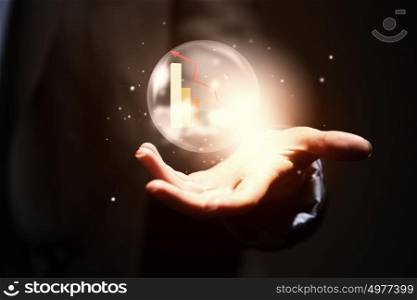 Business ambitions. Close up of businesswoman holding bubble with graphs in hand