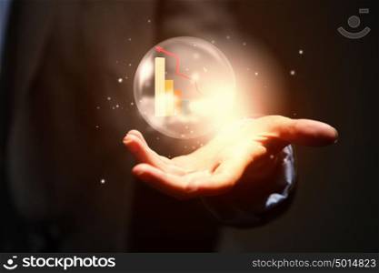 Business ambitions. Close up of businesswoman holding bubble with graphs in hand