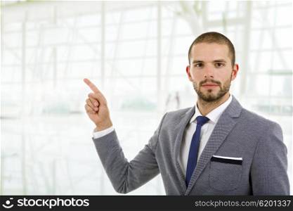 business an in a suit pointing with his finger, at the office