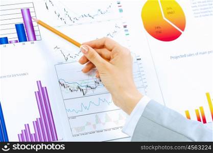 Business analysis. Close up image of human hand holding pencil. Marketing presentation