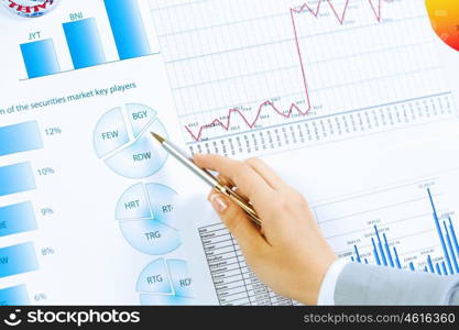 Business analysis. Close up image of human hand holding pencil. Marketing presentation