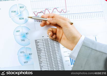 Business analysis. Close up image of human hand holding pencil. Marketing presentation