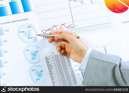 Business analysis. Close up image of human hand holding pencil. Marketing presentation