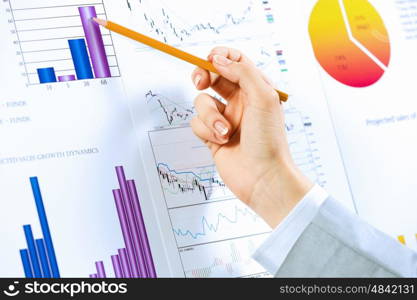 Business analysis. Close up image of human hand holding pencil. Marketing presentation