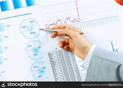 Business analysis. Close up image of human hand holding pencil. Marketing presentation
