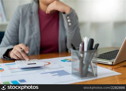 Business analyst concept the accountant using a calculator to figure out the number of the expense.