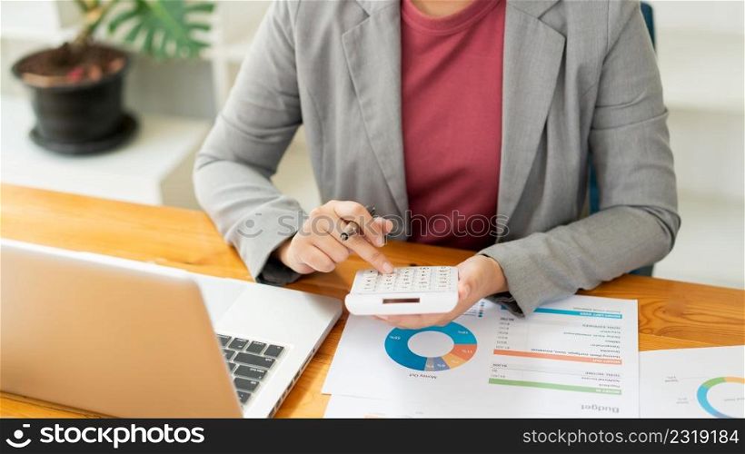 Business analyst concept the accountant using a calculator to figure out the number of the expense.